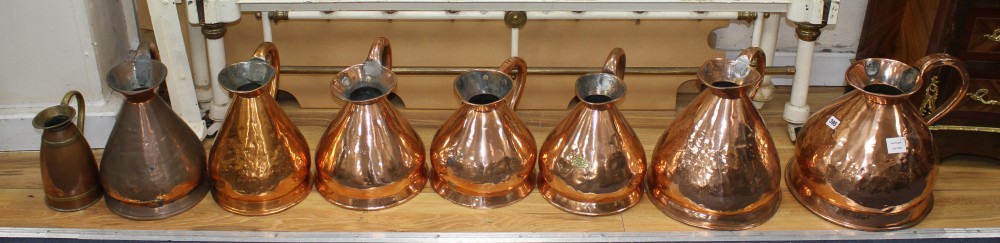 A collection of eight assorted copper flagons